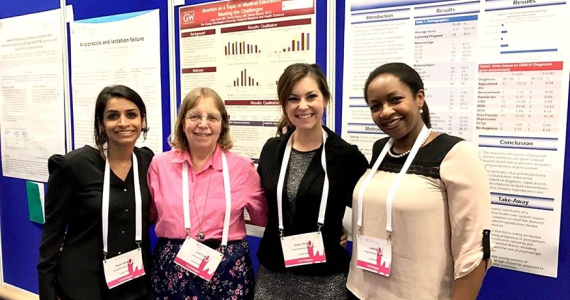 Group photo in front of research posters